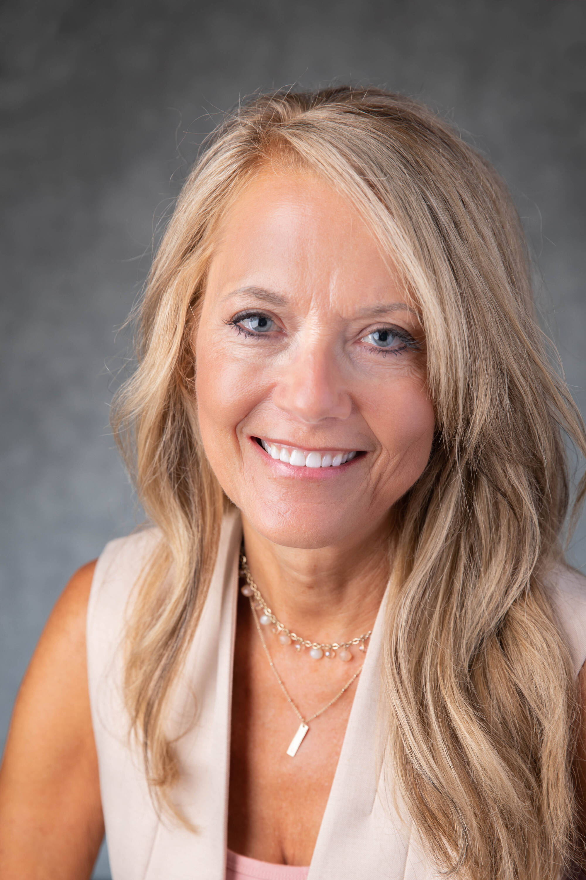 Image of Cheryl Kautz in a professional setting with a gray background.